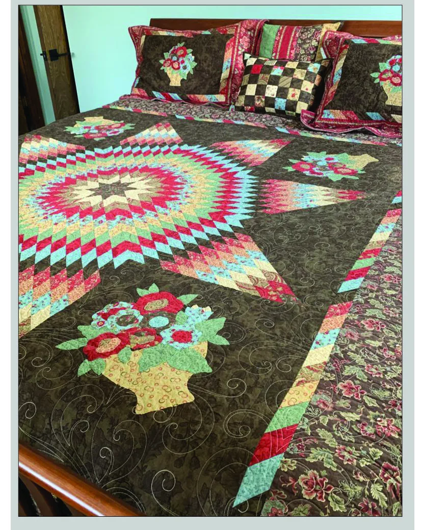 Star-pattern quilt with floral appliqué basket shown on a bed