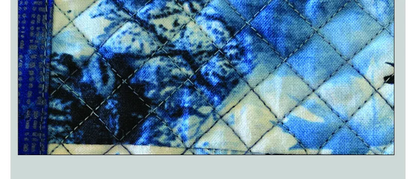 Blue tie-dye style quilt with a diamond quilting pattern