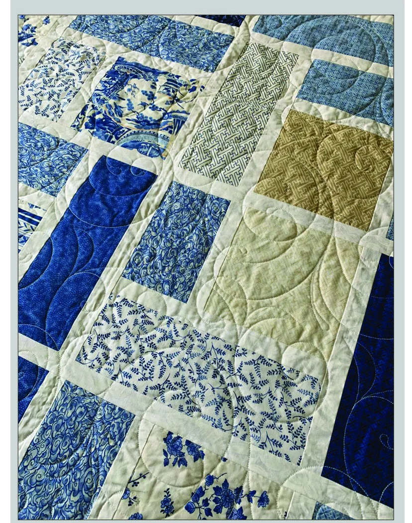 Blue and cream fabric quilt with circular quilting motifs